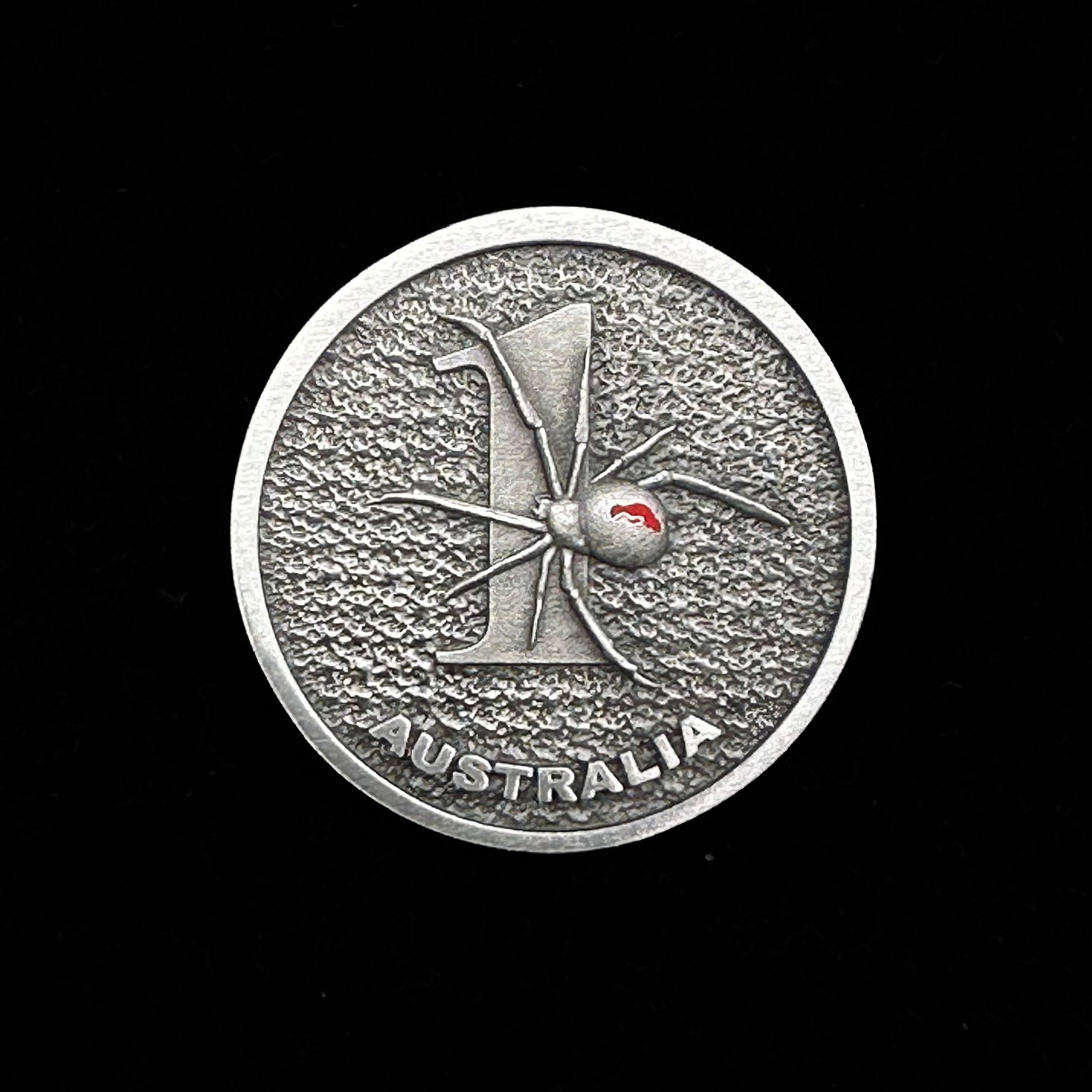 ninesixfour Australia one dollar coin with redback spider design and textured background