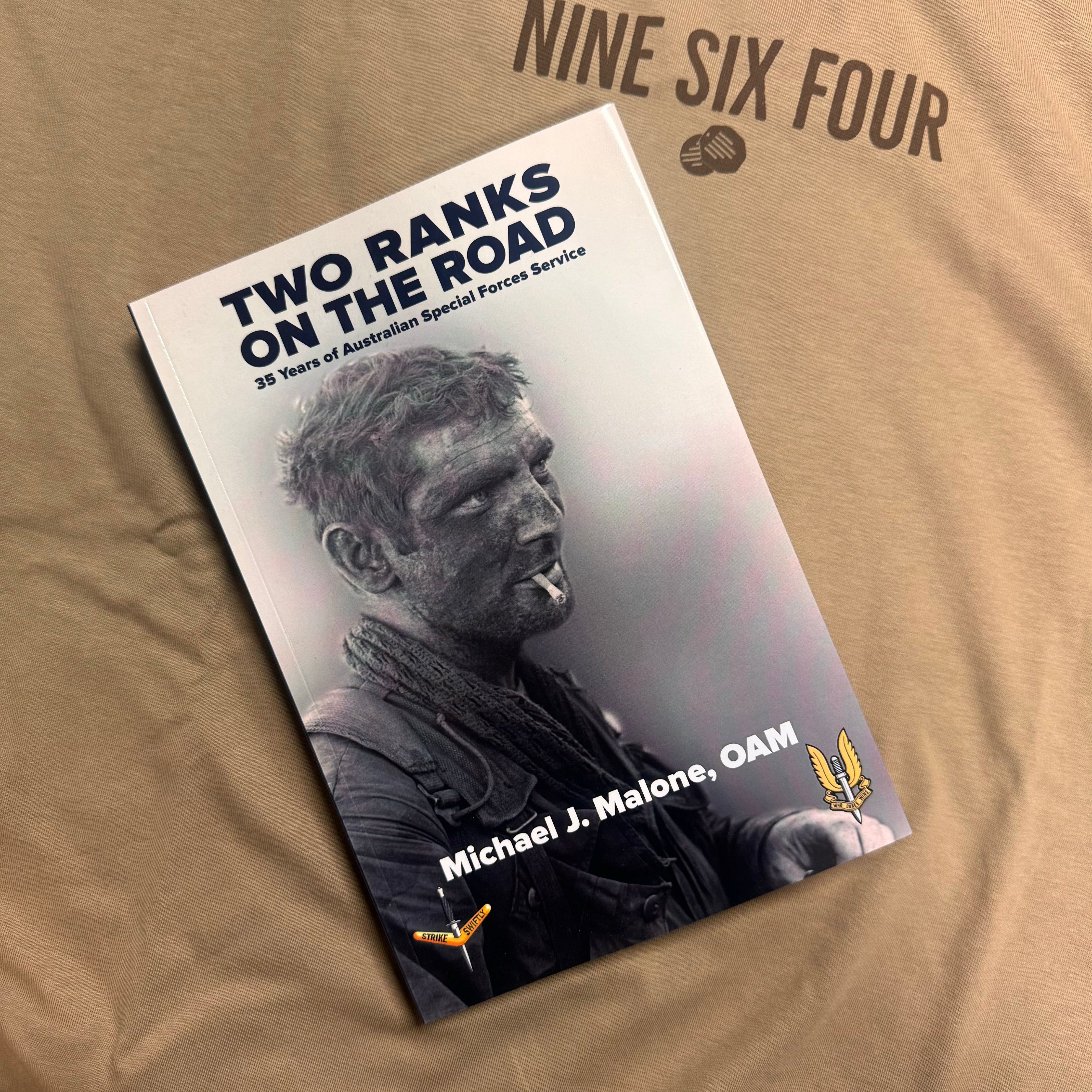 Two Ranks on the Road signed edition book by Michael J Malone on a beige Ninesixfour shirt
