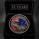 A commemorative oval coin for Operation Slipper 25 Years, displayed inside an open black velvet presentation box with '25 YEARS' engraved on the lid. The coin features a distressed Australian flag design with the Union Jack and stars, a brown mountain landscape, and red poppy emblems, with the text 'OPERATION SLIPPER 25 YEARS' and 'LEST WE FORGET'.