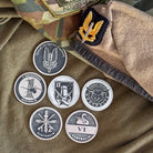 ninesixfour SASR challenge coin set featuring six detailed coins with military insignia on camouflage and fabric background