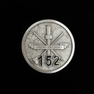 ninesixfour metal challenge coin with Ordo Ab Chao banner and number 152 on textured surface