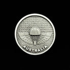 Silver Australia emblem featuring a parachute design on textured background